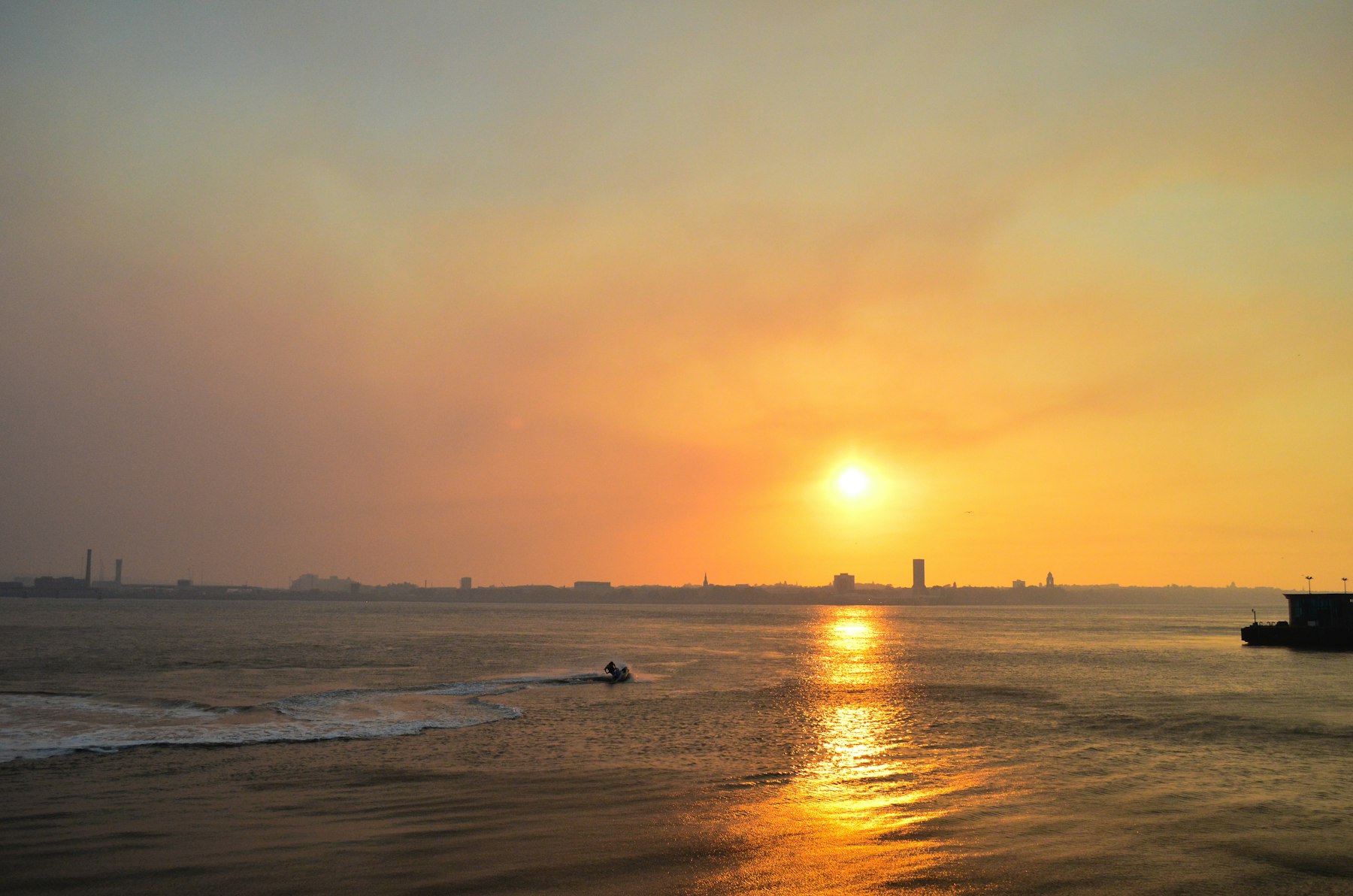 The sun setting over the River Mersey